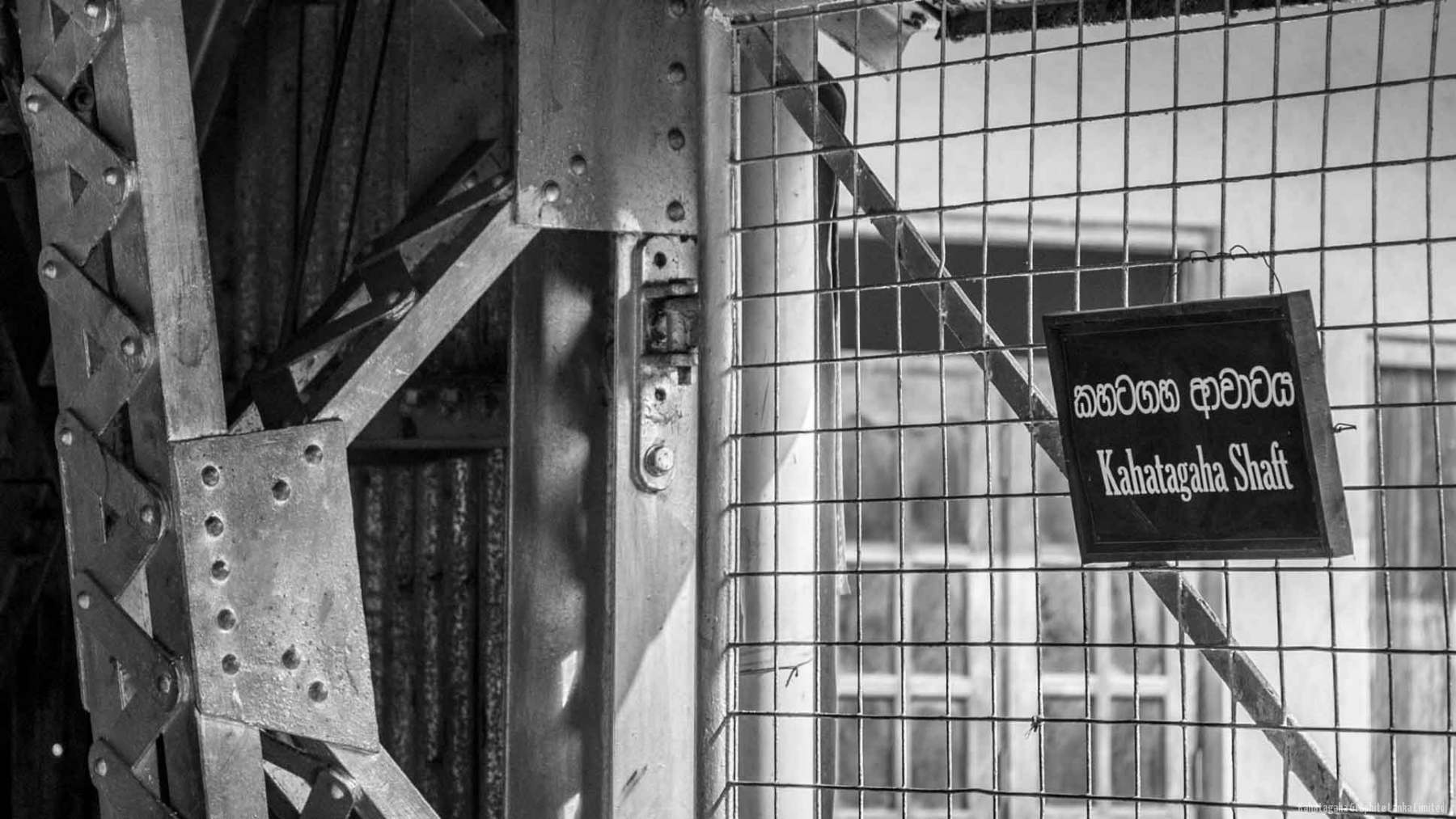 The steel headgear above the Kahatagaha shaft, with a bilingual sign reading Kahatagaha Shaft.